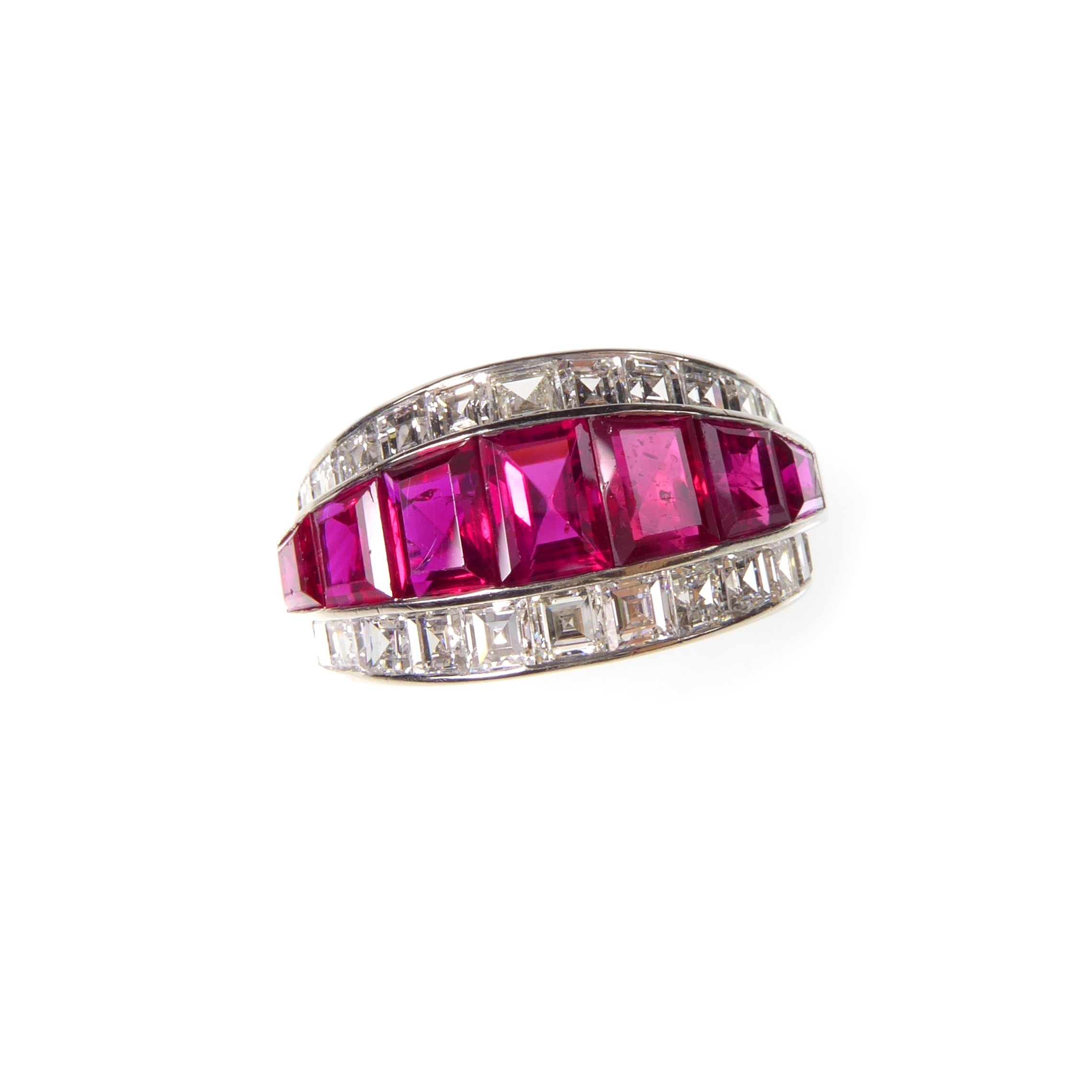 Ruby and diamond graduated three row half hoop ring, calibre tapered rectangular cut rubies flanked by stepped lines of square cut diamonds,
